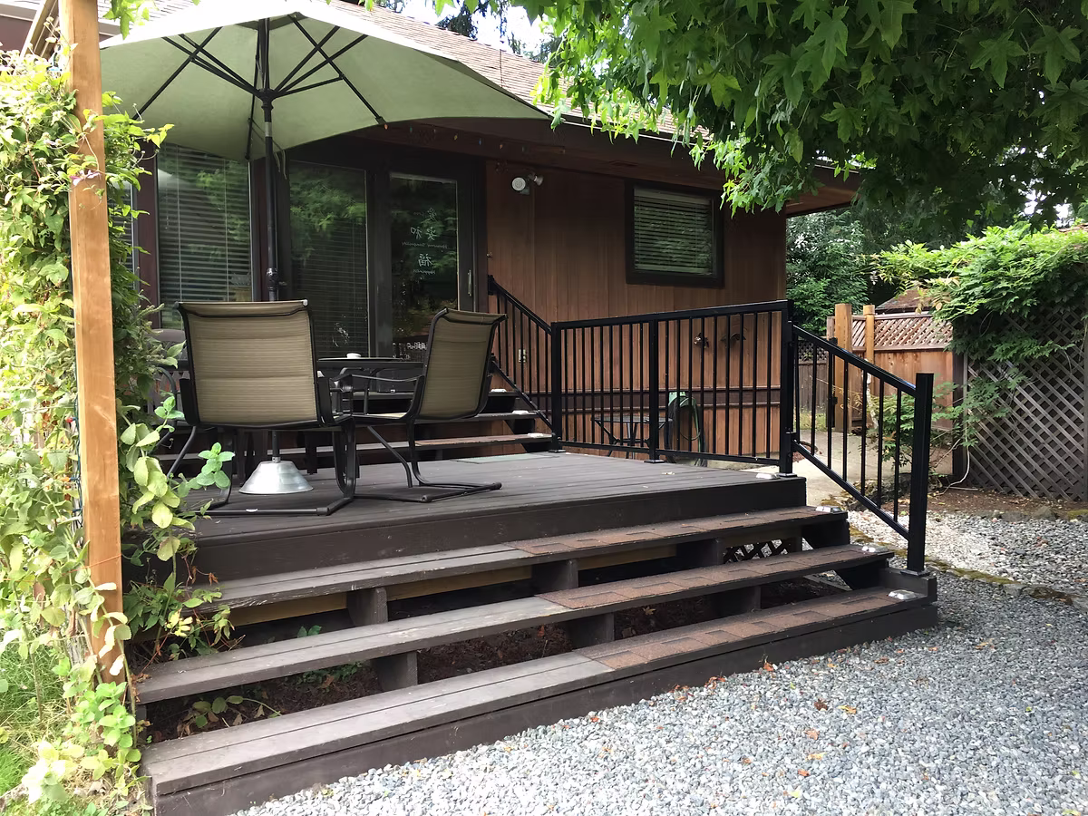 Cozy deck surrounded by greenery.