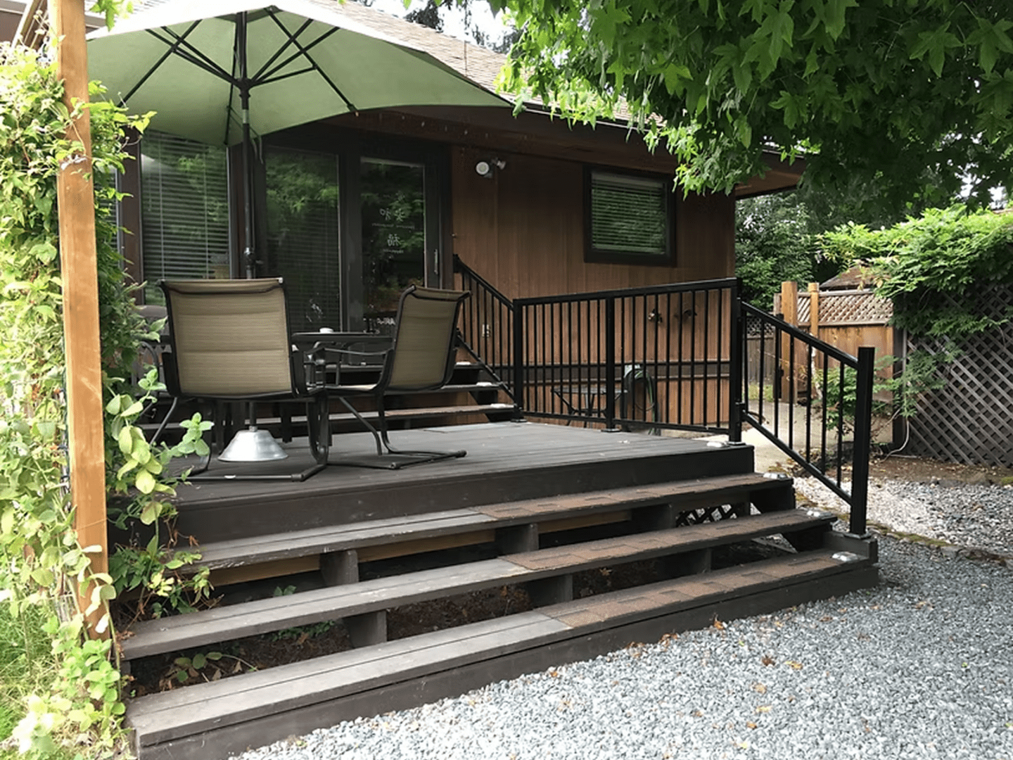 Wooden deck with patio chairs and umbrella