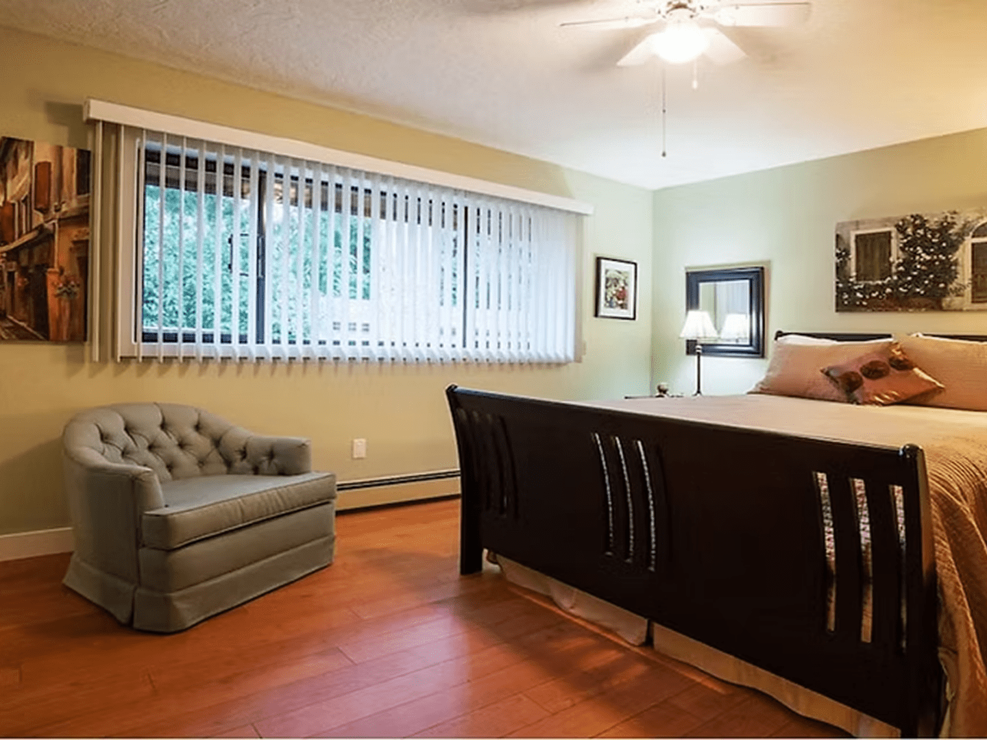 Spacious bedroom with large window blinds.