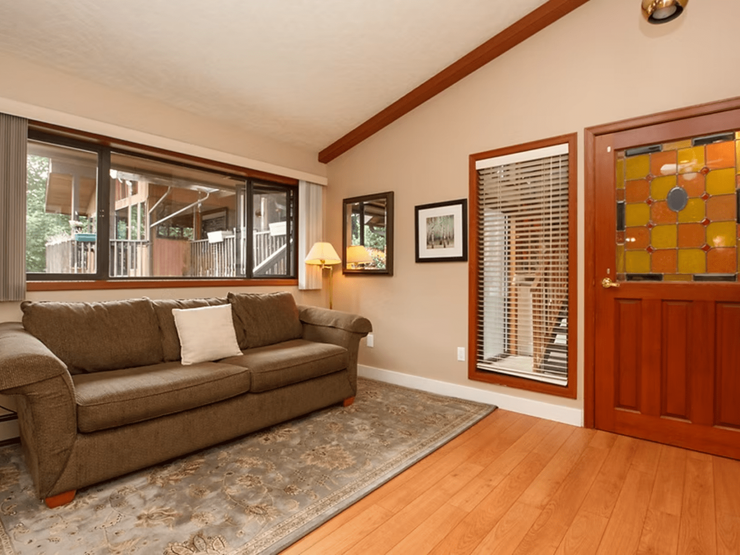 Bright room featuring large windows and couch