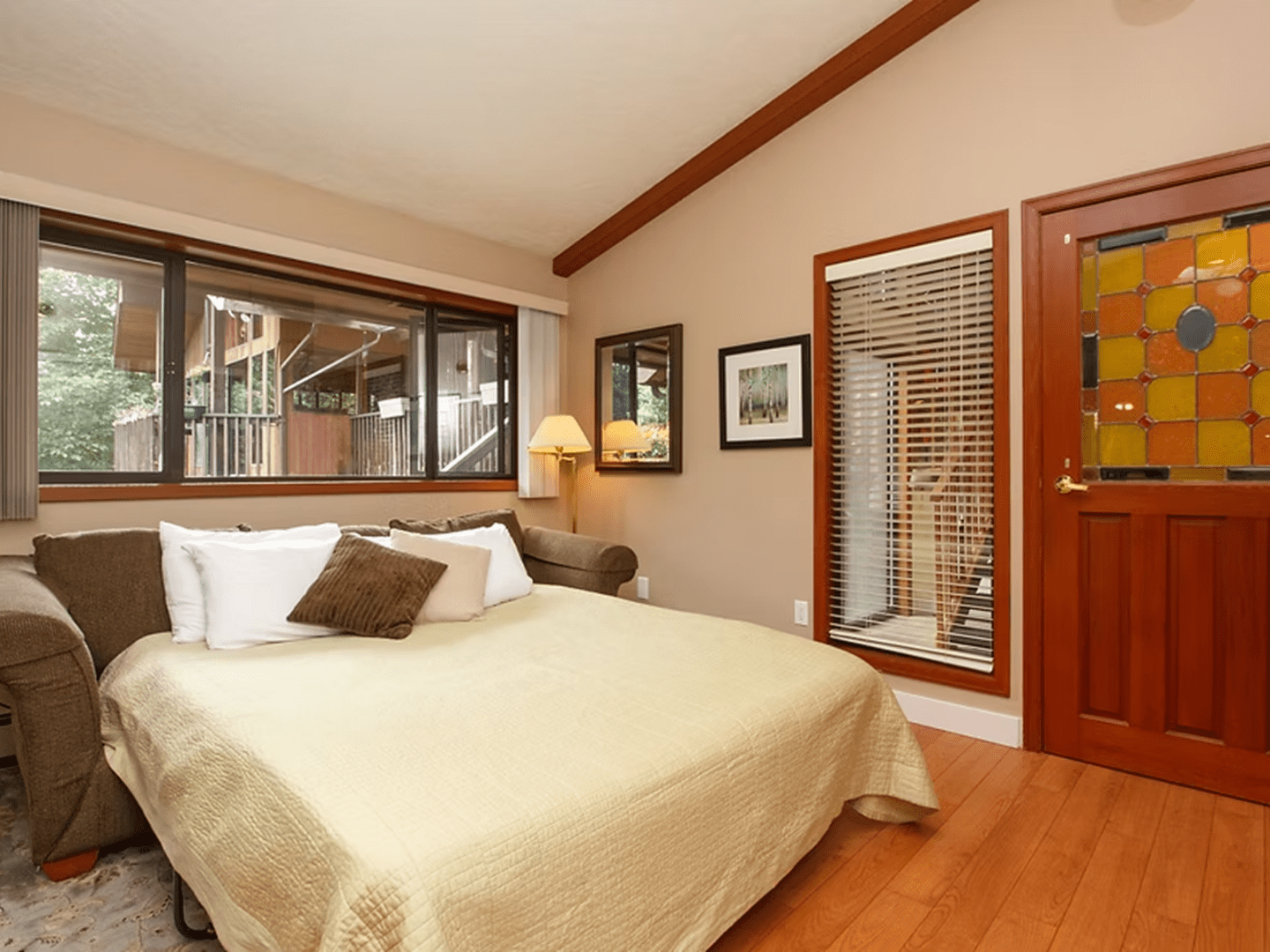Comfortable bed in inviting, rustic room