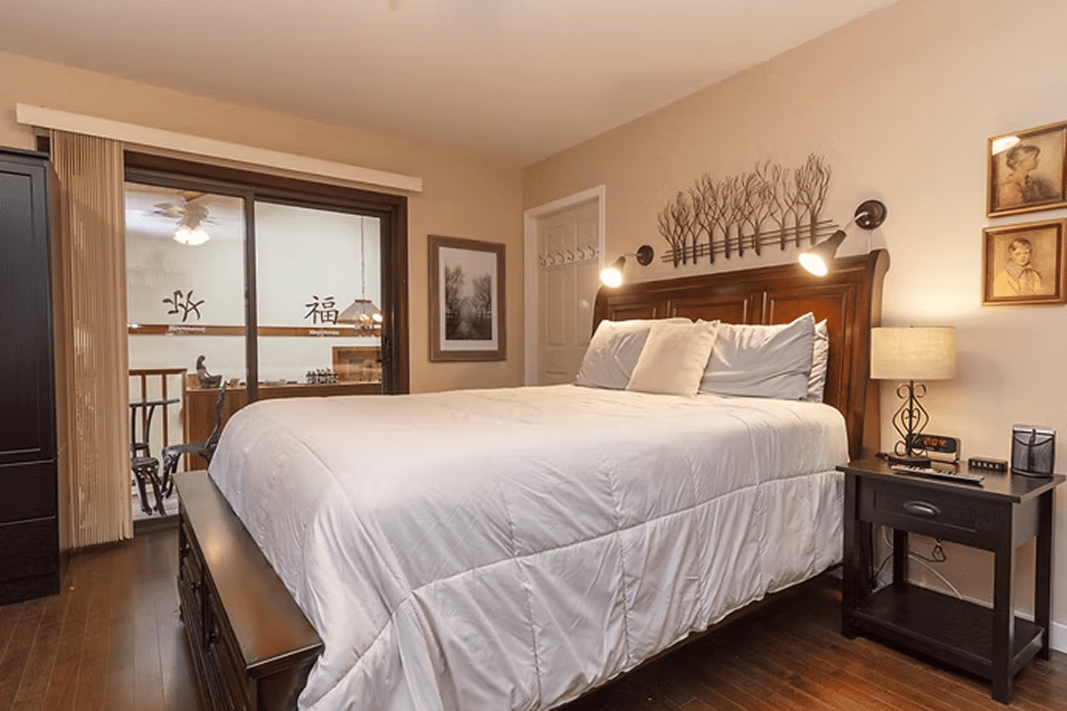 Comfortable bed in warmly lit room