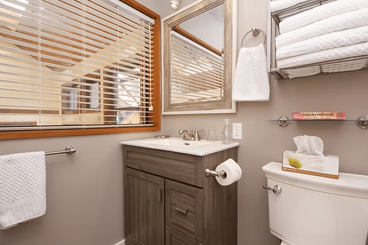 Cozy bathroom with window blinds and sink